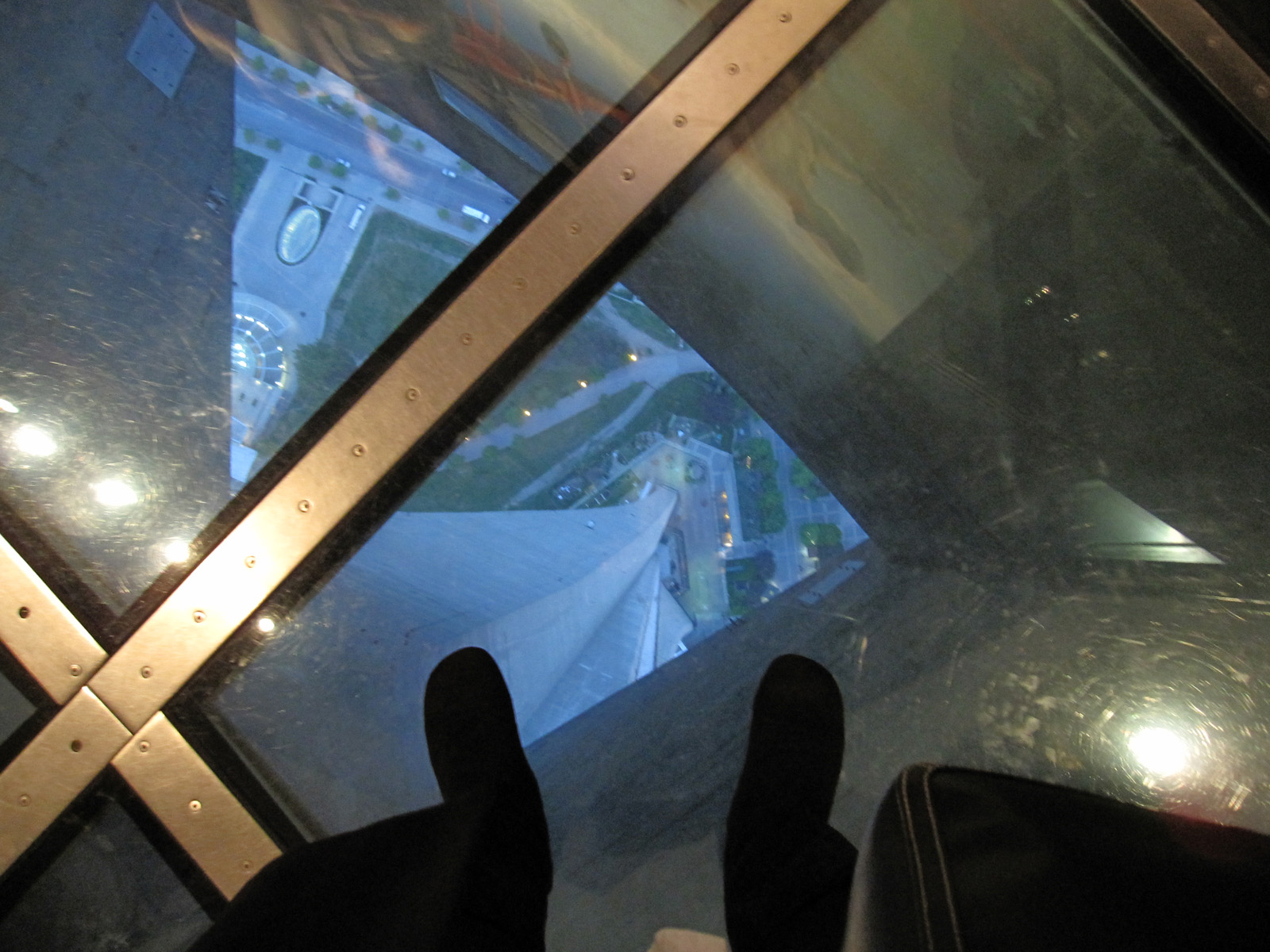 Looking straight down through the glass floor to the rails below